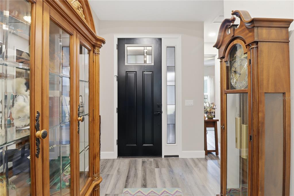 9689 East White Egret Path Inverness, FL 34450 - Photo 6 of 44 a view of a hallway with wooden floor and a bathroom
