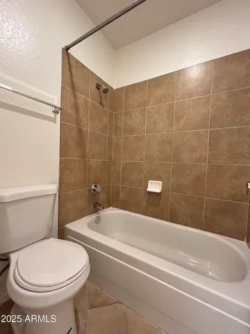 a bathroom with a toilet and a bathtub