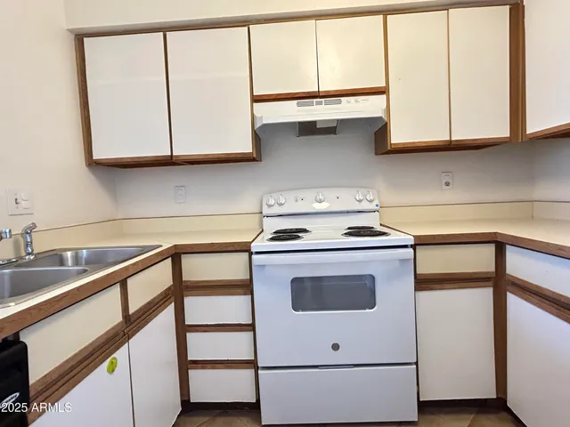 a kitchen with stainless steel appliances granite countertop a sink and a microwave