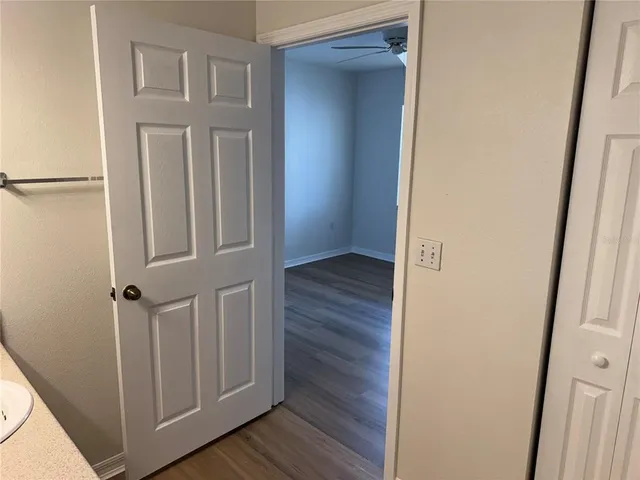 a view of a hallway with wooden floor and staircase