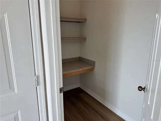 a view of hallway with wooden floor
