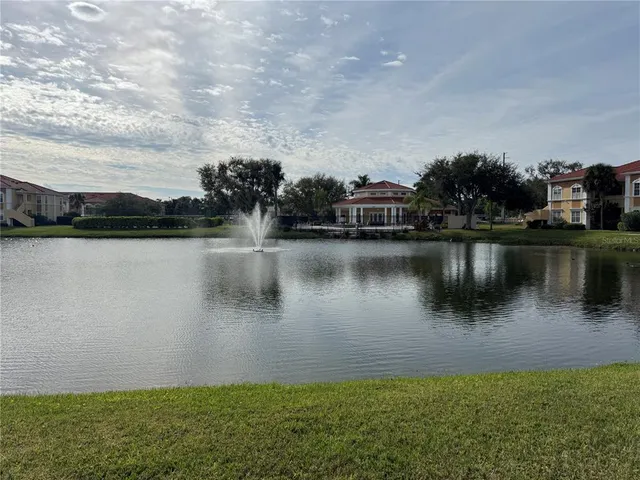 a view of a lake with houses in the back