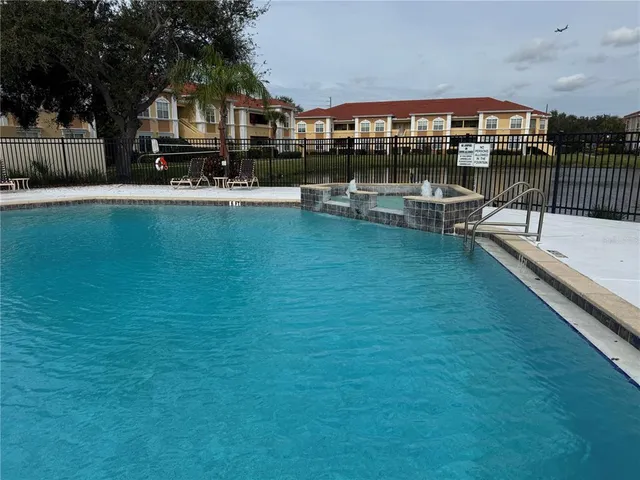 a front view of house with outdoor space and swimming pool