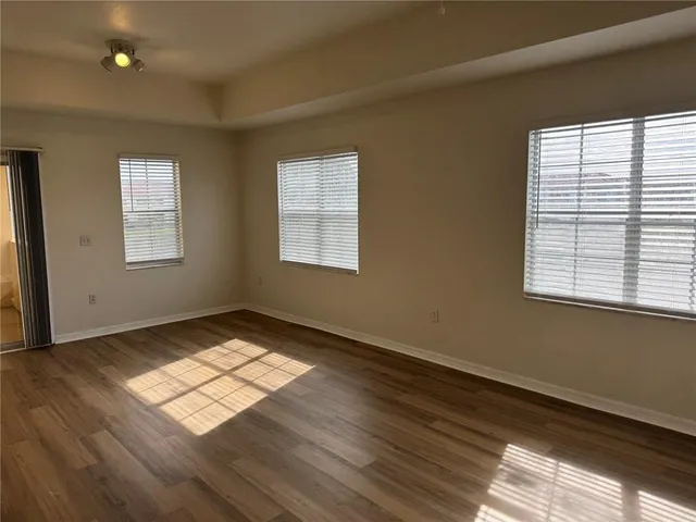 a view of wooden floor and windows in a room