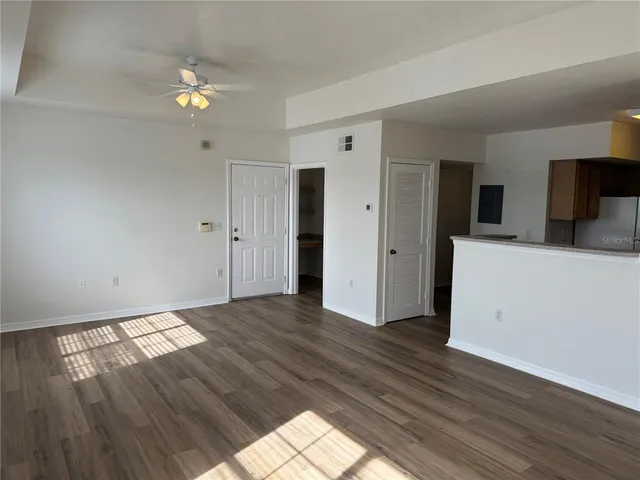 a view of empty room with wooden floor