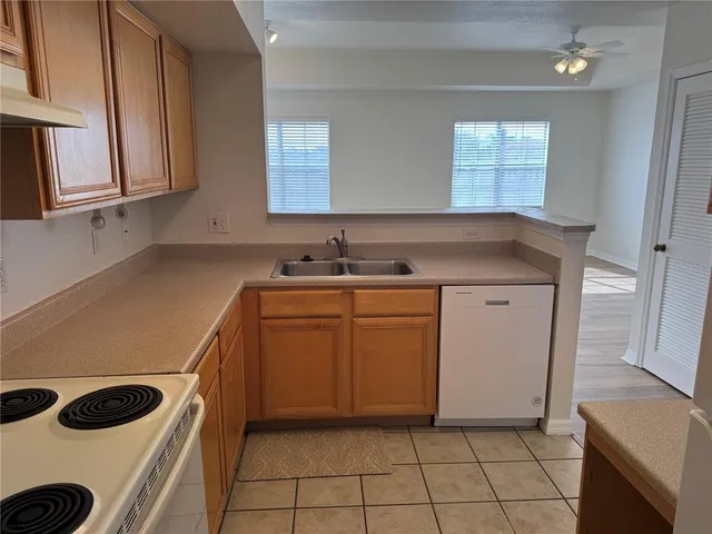 a kitchen with a sink a stove and cabinets