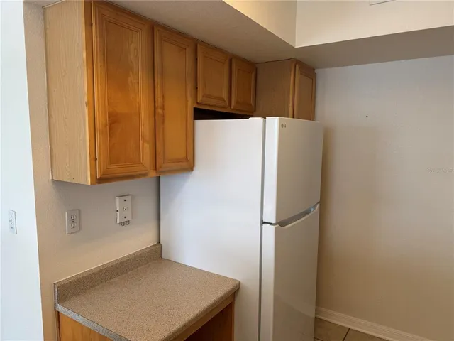a white refrigerator freezer sitting in a kitchen