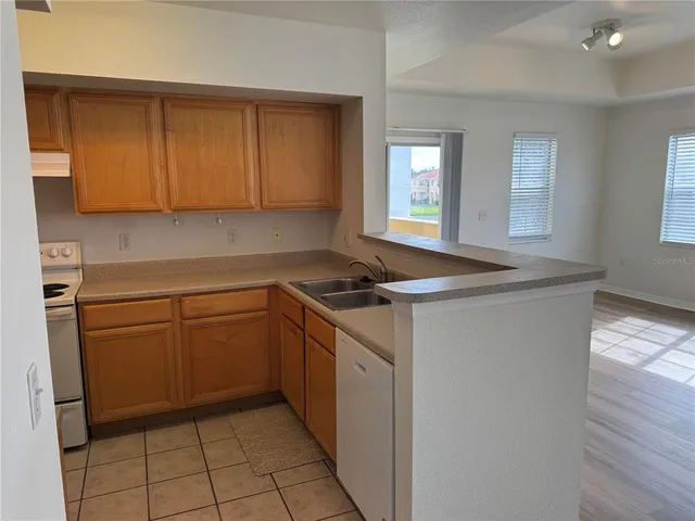 a kitchen with a sink cabinets and a window