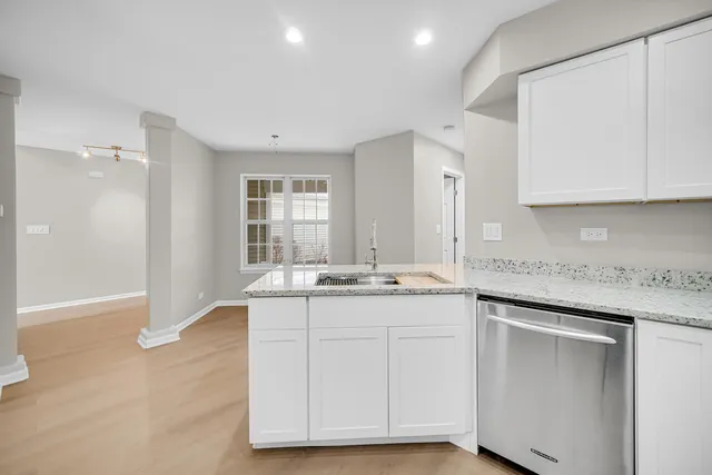 a kitchen with granite countertop a sink and cabinets