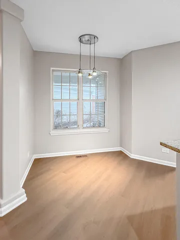 an empty room with a empty space and windows