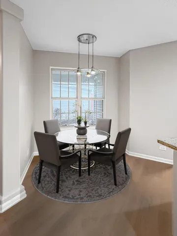 a view of a dining room with furniture wooden floor and chandelier