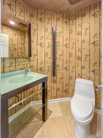 a bathroom with a sink toilet and shower