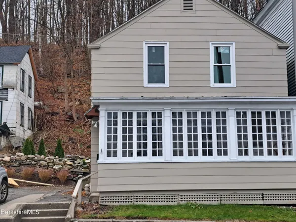 a view of a house with a window and a yard