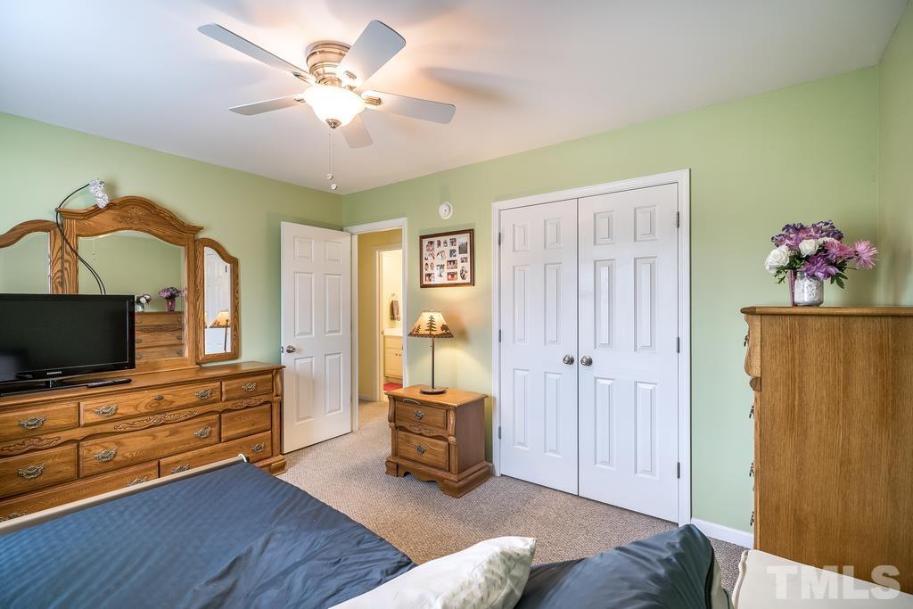 473 Axum Road Willow Spring, NC 27592 - Photo 22 of 30 a living room with furniture and flat screen tv