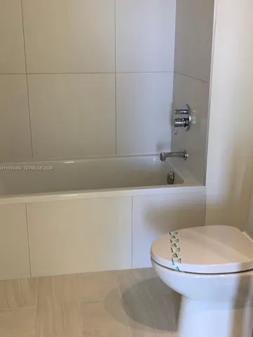 a bathroom with a toilet and a bathtub