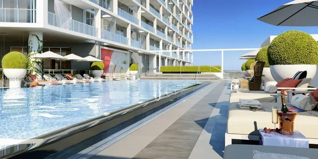 a view of swimming pool with outdoor seating