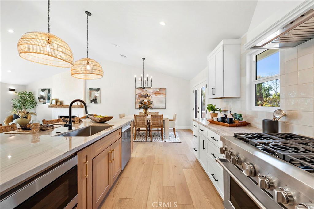 1850 Oriole Drive Costa Mesa, CA 92626 - Photo 12 of 33 a kitchen with kitchen island a sink stove and white cabinets