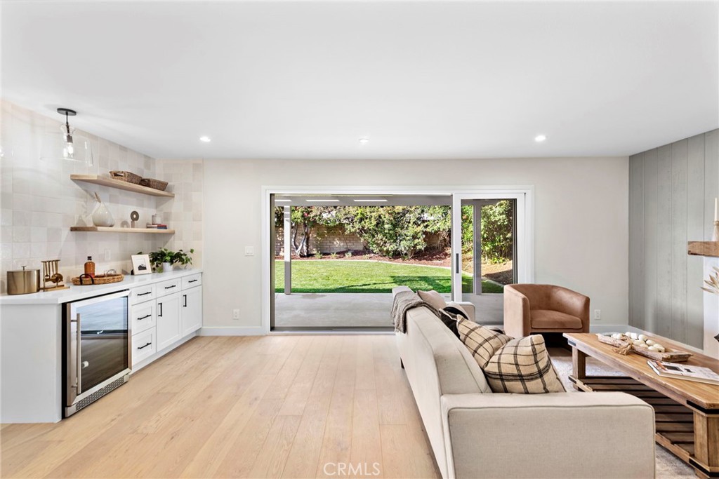 1850 Oriole Drive Costa Mesa, CA 92626 - Photo 16 of 33 a living room with furniture fireplace and large windows