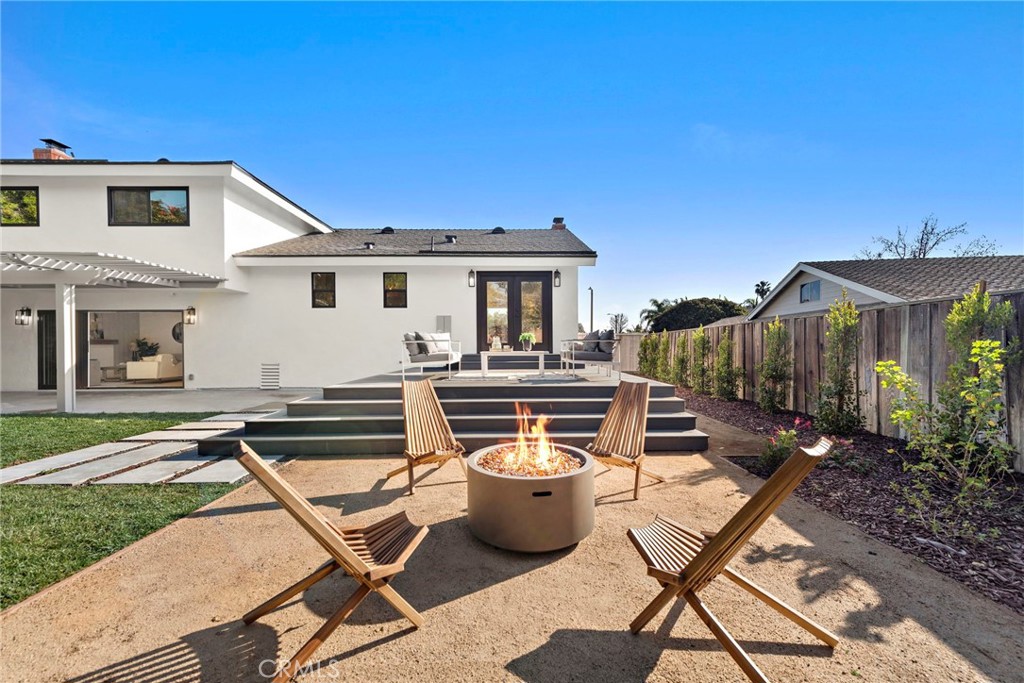 1850 Oriole Drive Costa Mesa, CA 92626 - Photo 21 of 33 a view of a patio with table and chairs with wooden floor and fence