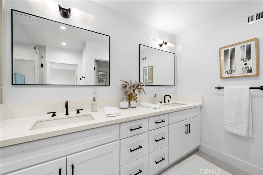 1850 Oriole Drive Costa Mesa, CA 92626 - Photo 25 of 33 a bathroom with double sink and a mirror