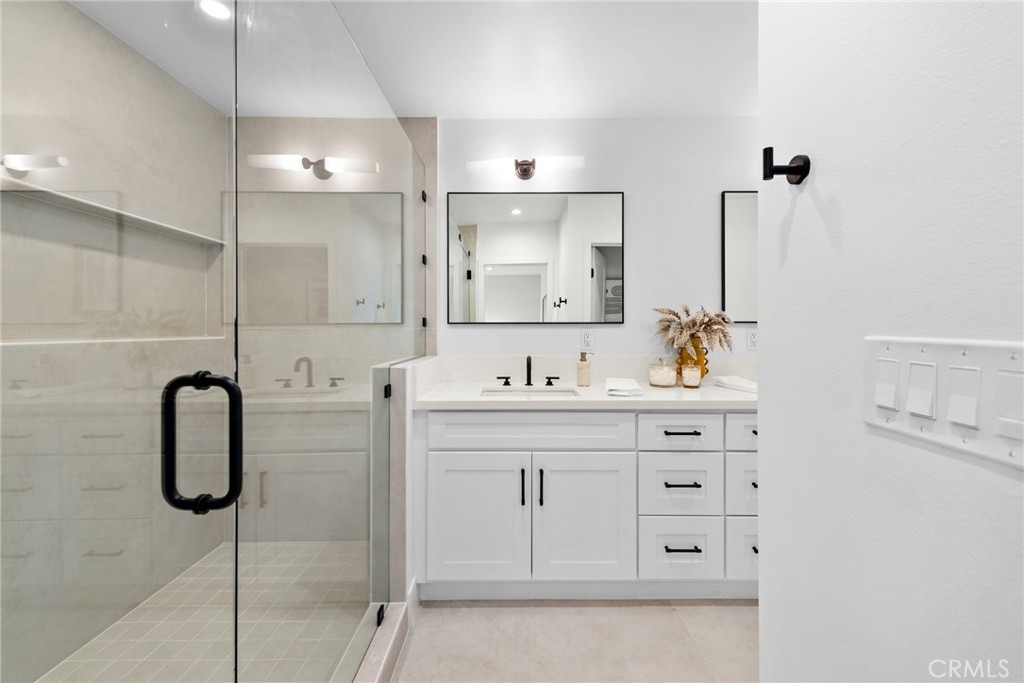 1850 Oriole Drive Costa Mesa, CA 92626 - Photo 26 of 33 a bathroom with a shower sink and mirror
