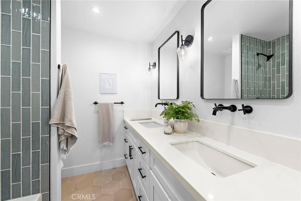 1850 Oriole Drive Costa Mesa, CA 92626 - Photo 29 of 33 a bathroom with a tub sink and mirror