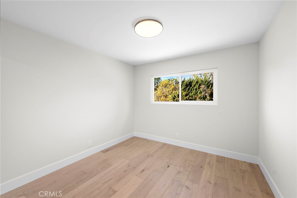 1850 Oriole Drive Costa Mesa, CA 92626 - Photo 31 of 33 an empty room with a fan and a window