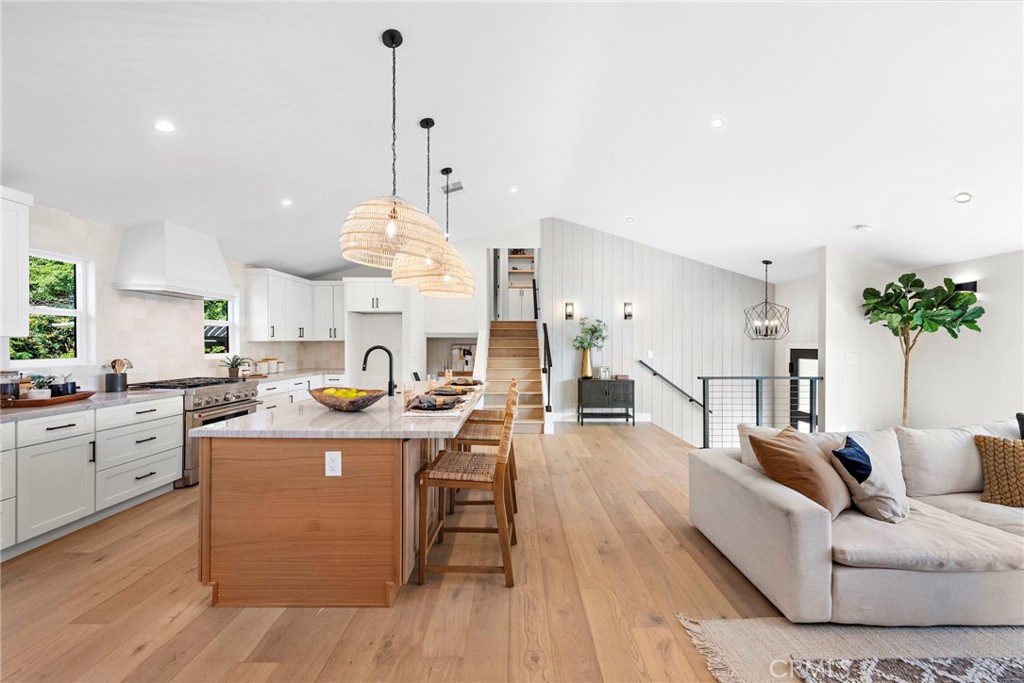 1850 Oriole Drive Costa Mesa, CA 92626 - Photo 10 of 33 a living room with furniture a chandelier and a dining table