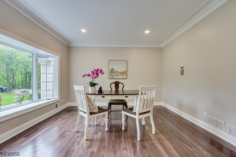 270 Mountain Road Bernards, NJ 07920 - Photo 18 of 41 a view of a dining room with furniture a potted plant and wooden floor