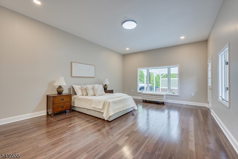 270 Mountain Road Bernards, NJ 07920 - Photo 21 of 41 a spacious bedroom with a bed and a wooden floor