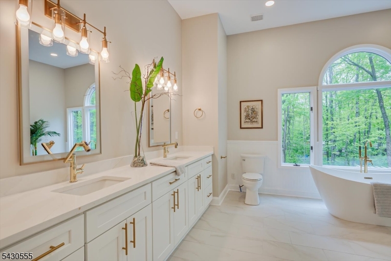 270 Mountain Road Bernards, NJ 07920 - Photo 28 of 41 a bathroom with a double vanity sink and a bathtub