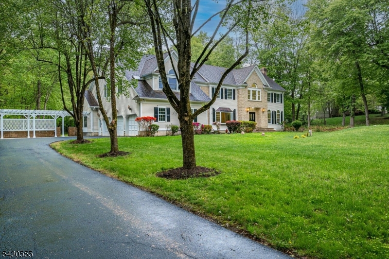 270 Mountain Road Bernards, NJ 07920 - Photo 3 of 41 a front view of a house with a yard and trees