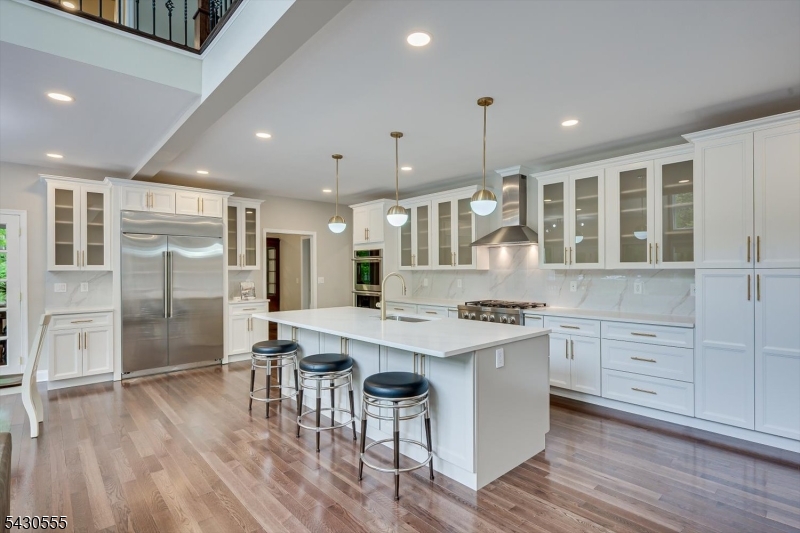 270 Mountain Road Bernards, NJ 07920 - Photo 10 of 41 a kitchen with stainless steel appliances kitchen island granite countertop a stove a refrigerator a sink and white cabinets with wooden floor