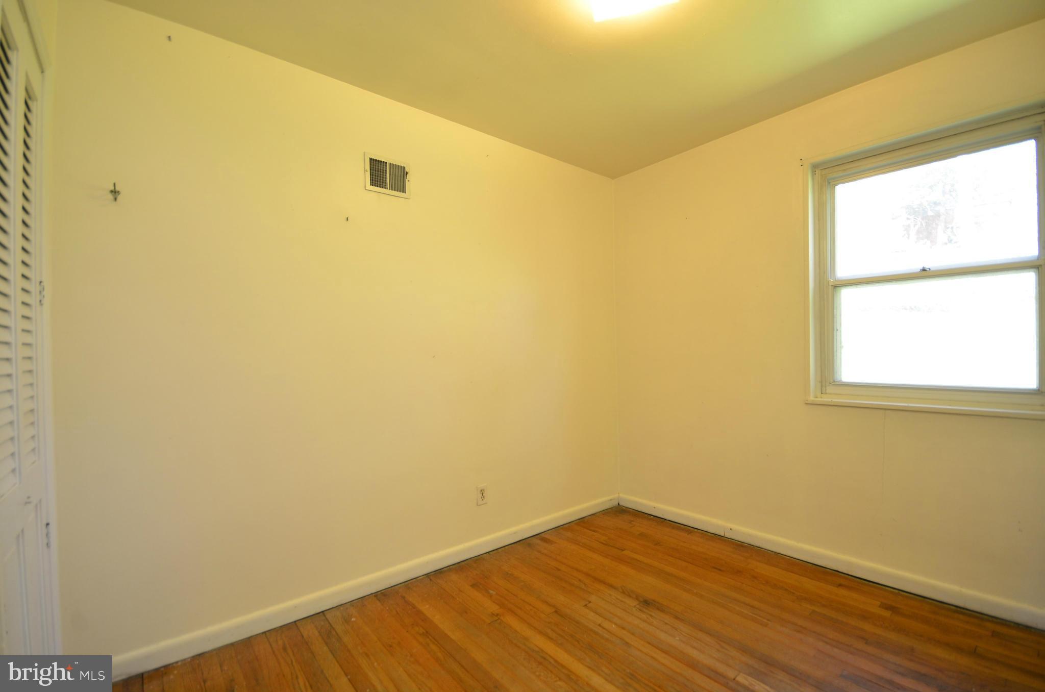 11620 Gail Street Silver Spring, MD 20902 - Photo 11 of 21 a view of a room with wooden floor and a window