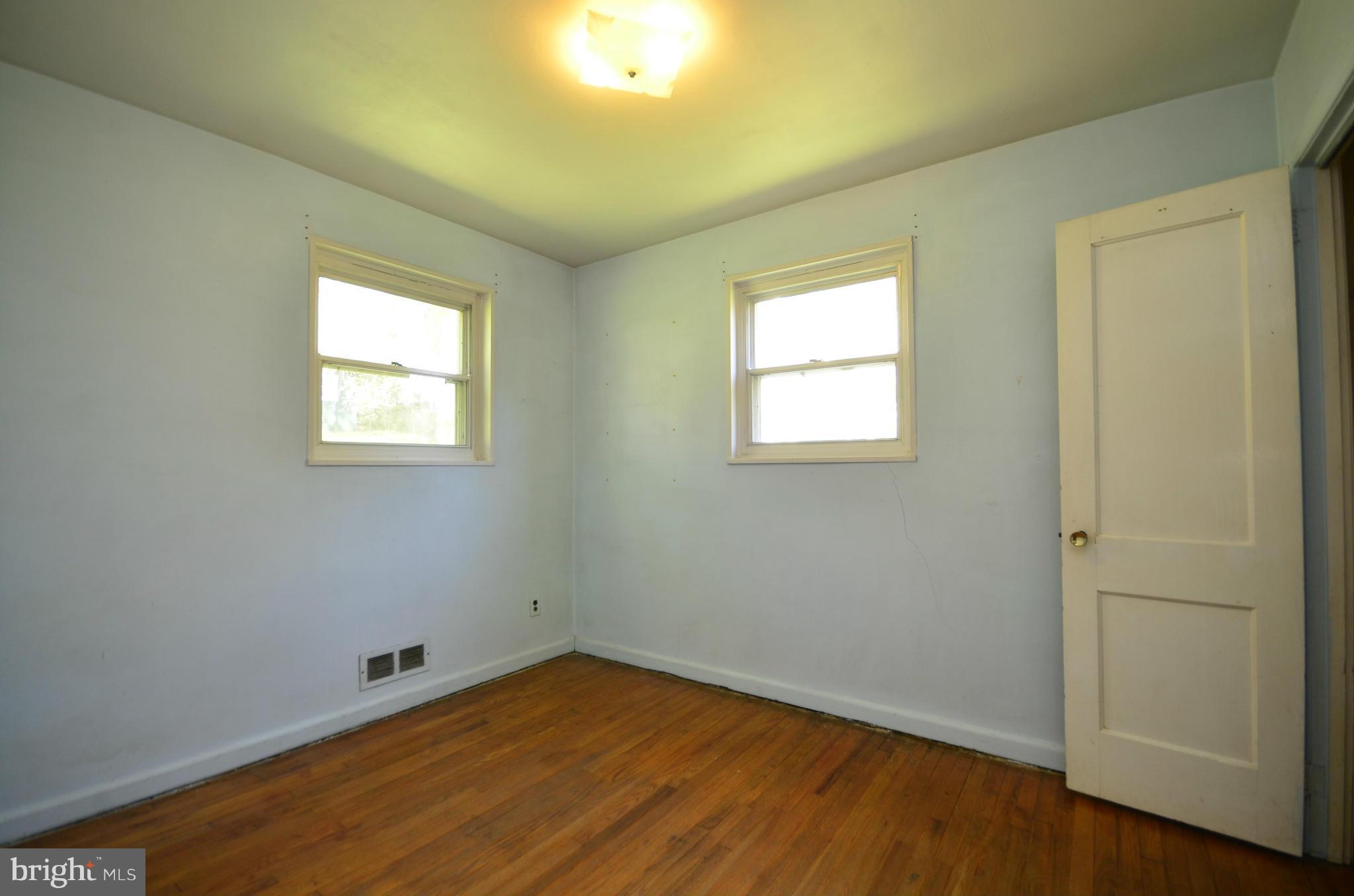 11620 Gail Street Silver Spring, MD 20902 - Photo 13 of 21 an empty room with wooden floor and windows