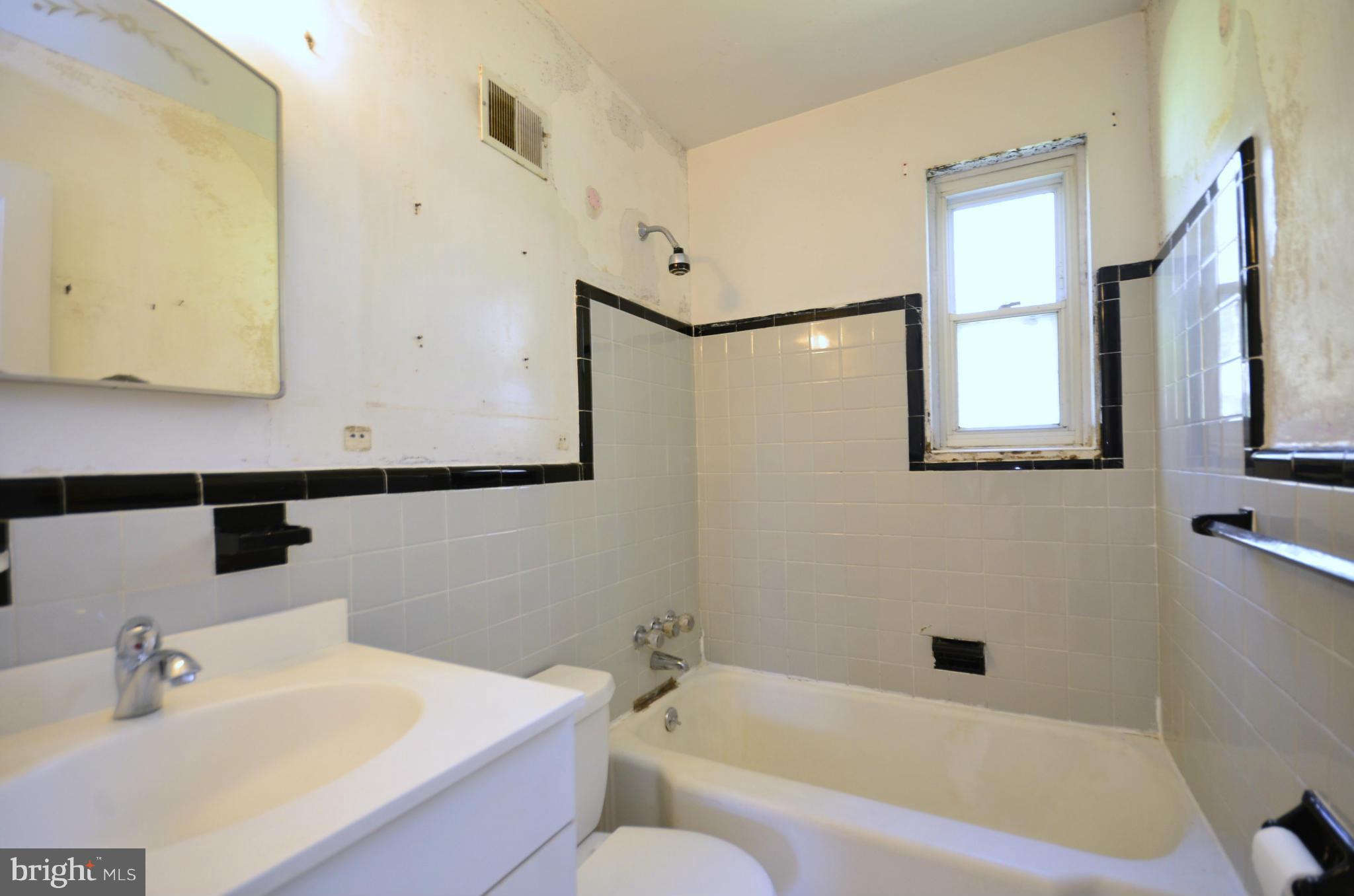 11620 Gail Street Silver Spring, MD 20902 - Photo 17 of 21 a bathroom with a sink mirror and a bathtub