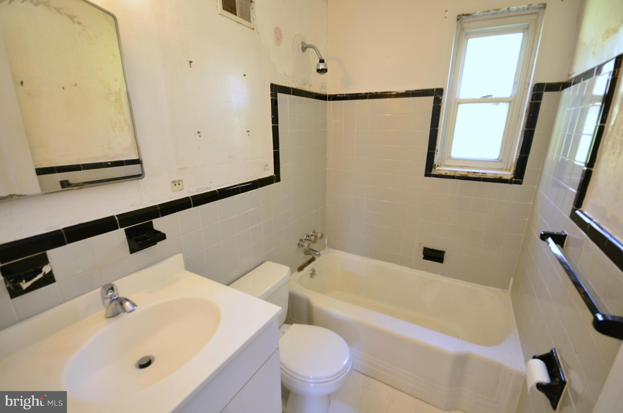 11620 Gail Street Silver Spring, MD 20902 - Photo 18 of 21 a bathroom with a sink mirror vanity and toilet