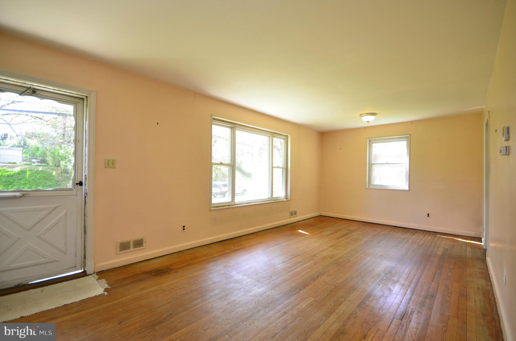 11620 Gail Street Silver Spring, MD 20902 - Photo 4 of 21 an empty room with wooden floor and windows