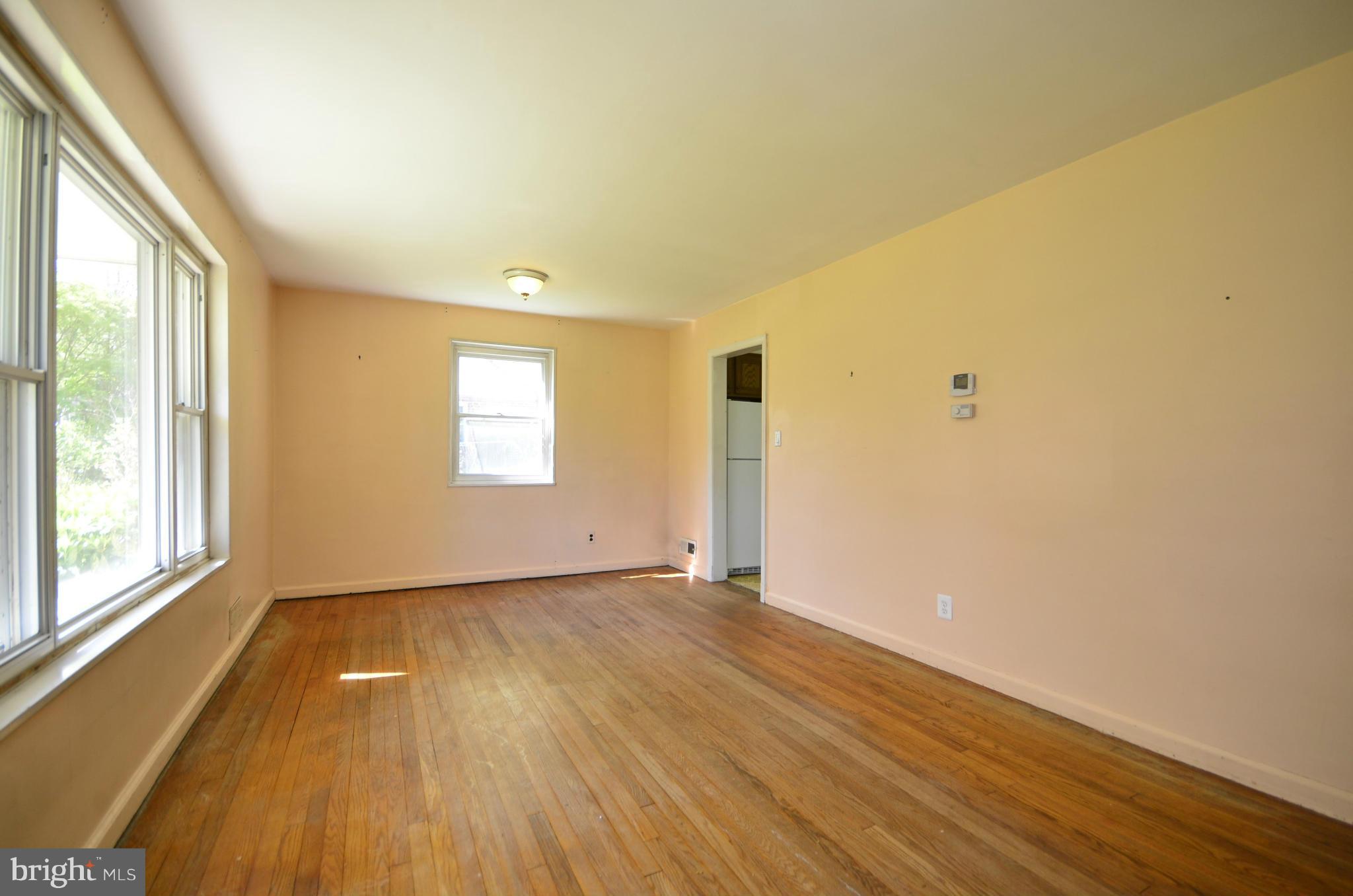11620 Gail Street Silver Spring, MD 20902 - Photo 5 of 21 an empty room with wooden floor and windows