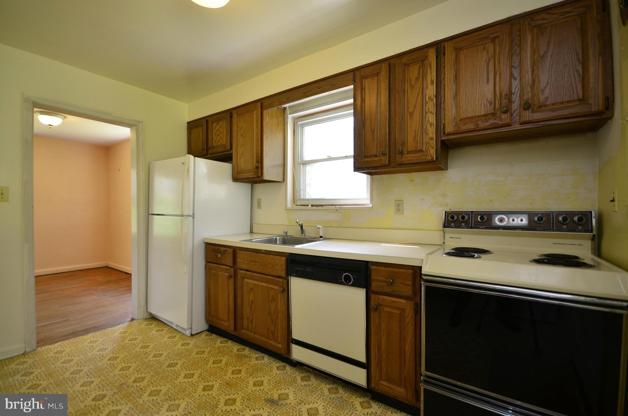 11620 Gail Street Silver Spring, MD 20902 - Photo 9 of 21 a kitchen with a sink stove and refrigerator