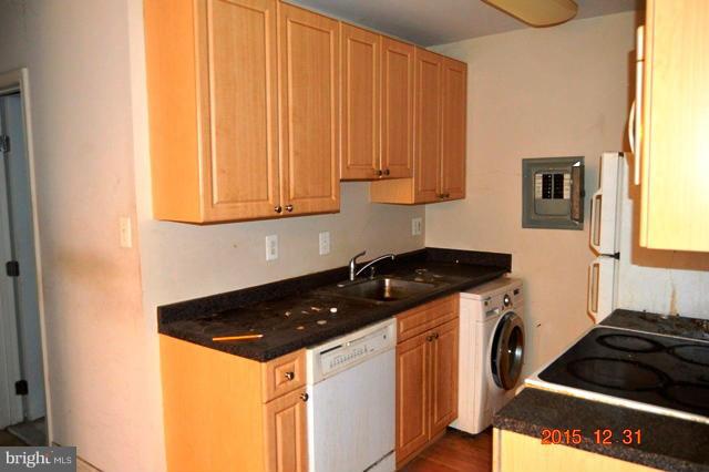 1009 Chillum Road, Unit 202 Hyattsville, MD 20782 - Photo 5 of 6 a kitchen with a stove and a cabinet