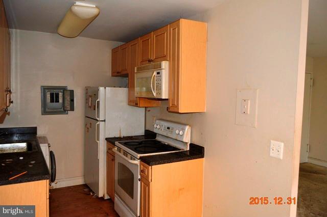 1009 Chillum Road, Unit 202 Hyattsville, MD 20782 - Photo 6 of 6 a kitchen with a sink a refrigerator and cabinets