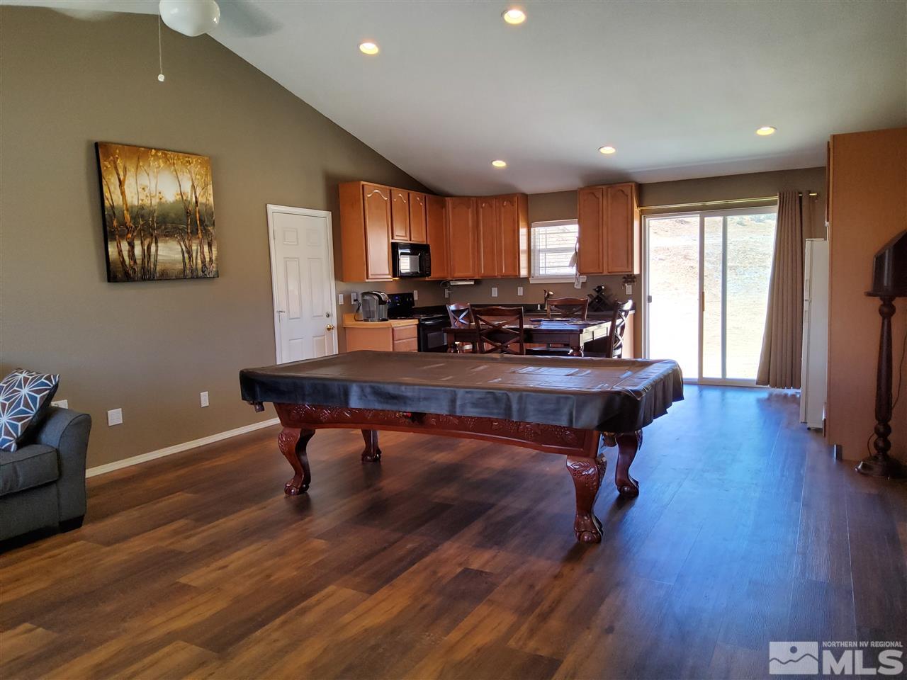 190 Curnow Canyon Road Reno, NV 89510 - Photo 4 of 27 a room with furniture pool table wooden floor and windows