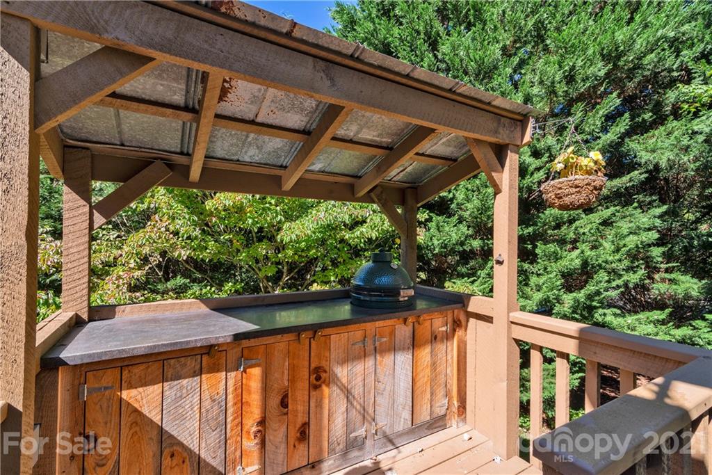 243 Rivermont Drive Canton, NC 28716 - Photo 13 of 29 a view of a patio with table and chairs under an umbrella with a small yard