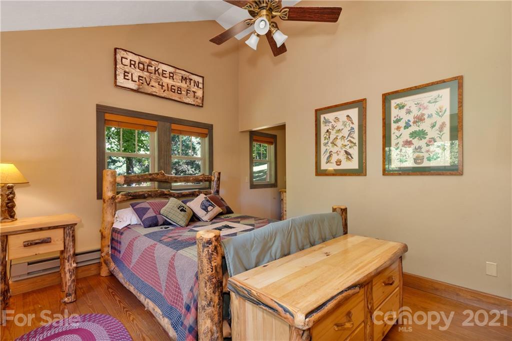 243 Rivermont Drive Canton, NC 28716 - Photo 15 of 29 a bed room with a bed and a chandelier