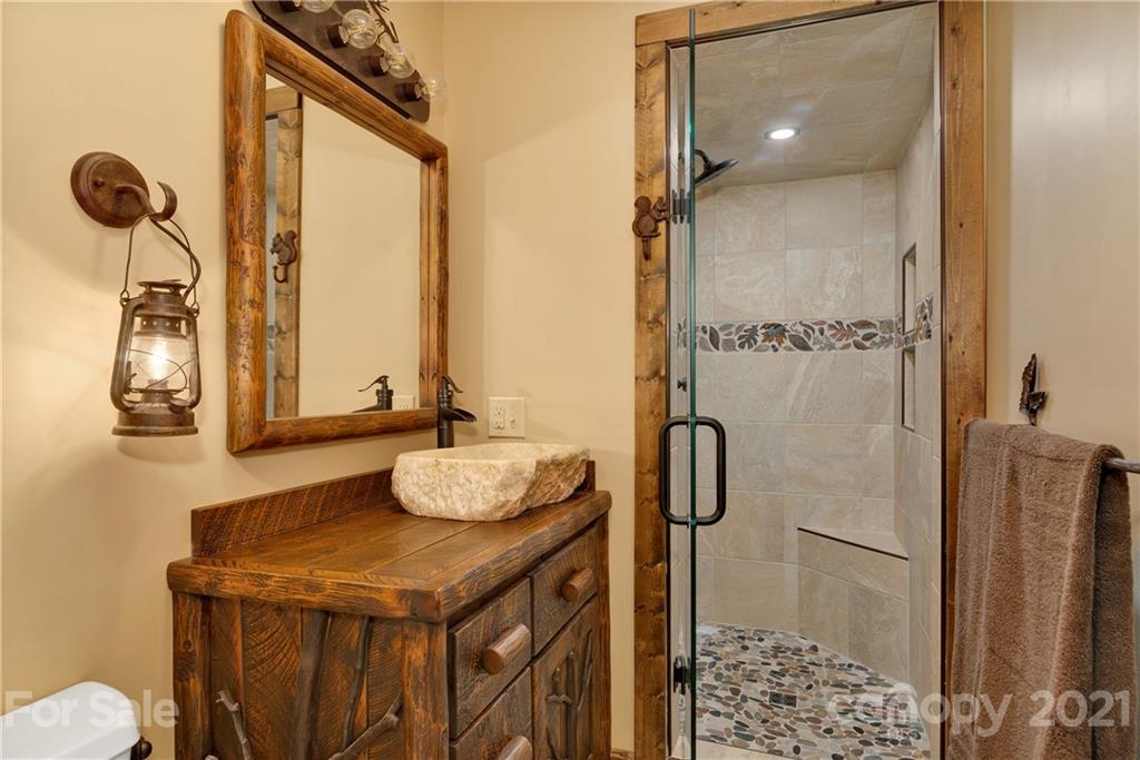 243 Rivermont Drive Canton, NC 28716 - Photo 16 of 29 a bathroom with a granite countertop sink and a mirror