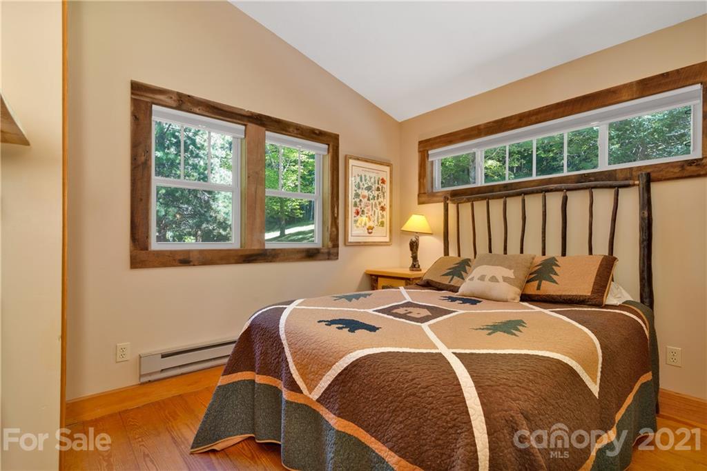 243 Rivermont Drive Canton, NC 28716 - Photo 18 of 29 a bed sitting in a bedroom next to a window