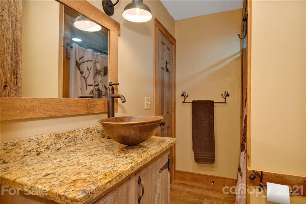 243 Rivermont Drive Canton, NC 28716 - Photo 19 of 29 a bathroom with a granite countertop sink and a mirror