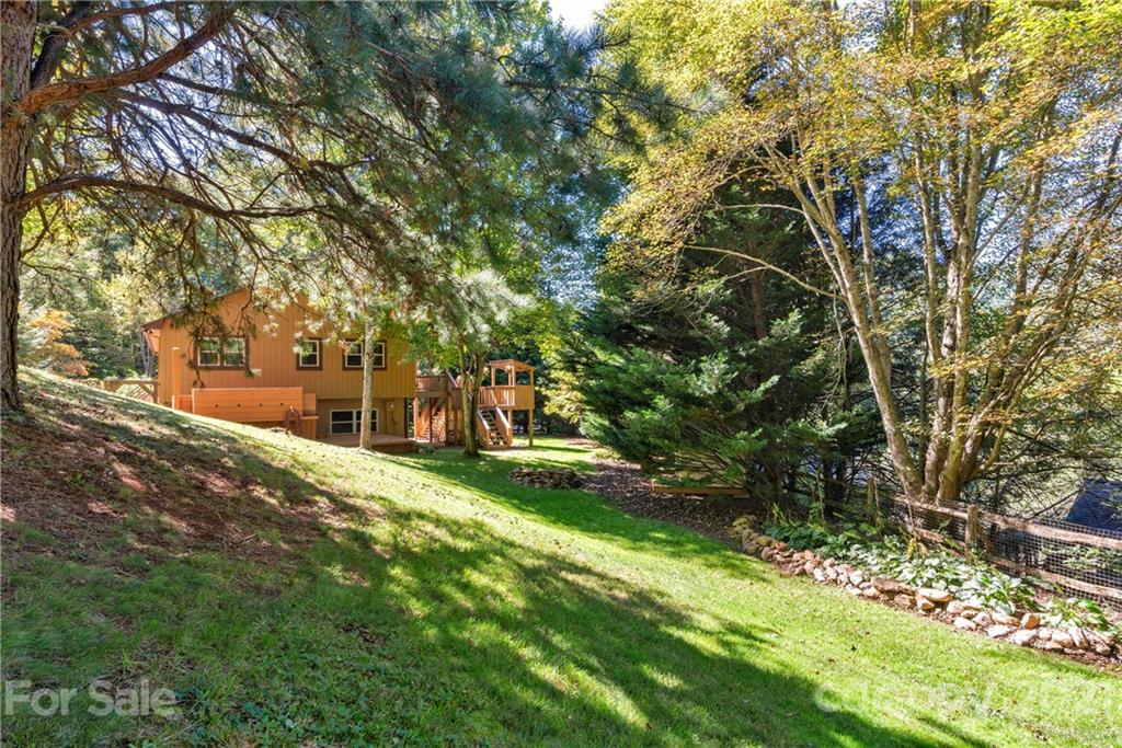 243 Rivermont Drive Canton, NC 28716 - Photo 26 of 29 a view of a yard with plants and trees