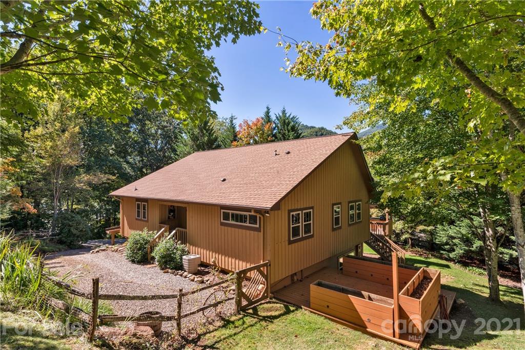 243 Rivermont Drive Canton, NC 28716 - Photo 28 of 29 a aerial view of a house with table and chairs under an umbrella